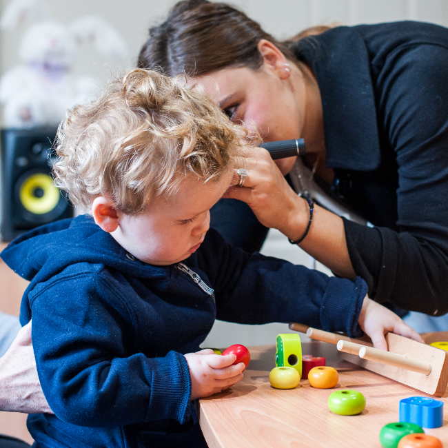 Audiologist in Adelaide Paediatric hearing clinic performing a play audiometry assessment