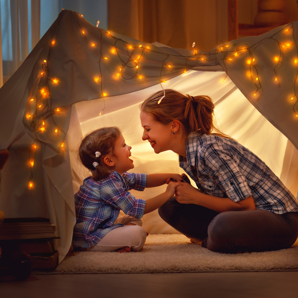 Child playing in tent with mother and their communication is improved by a cochlear implant provided by Little Allied Health Adelaide