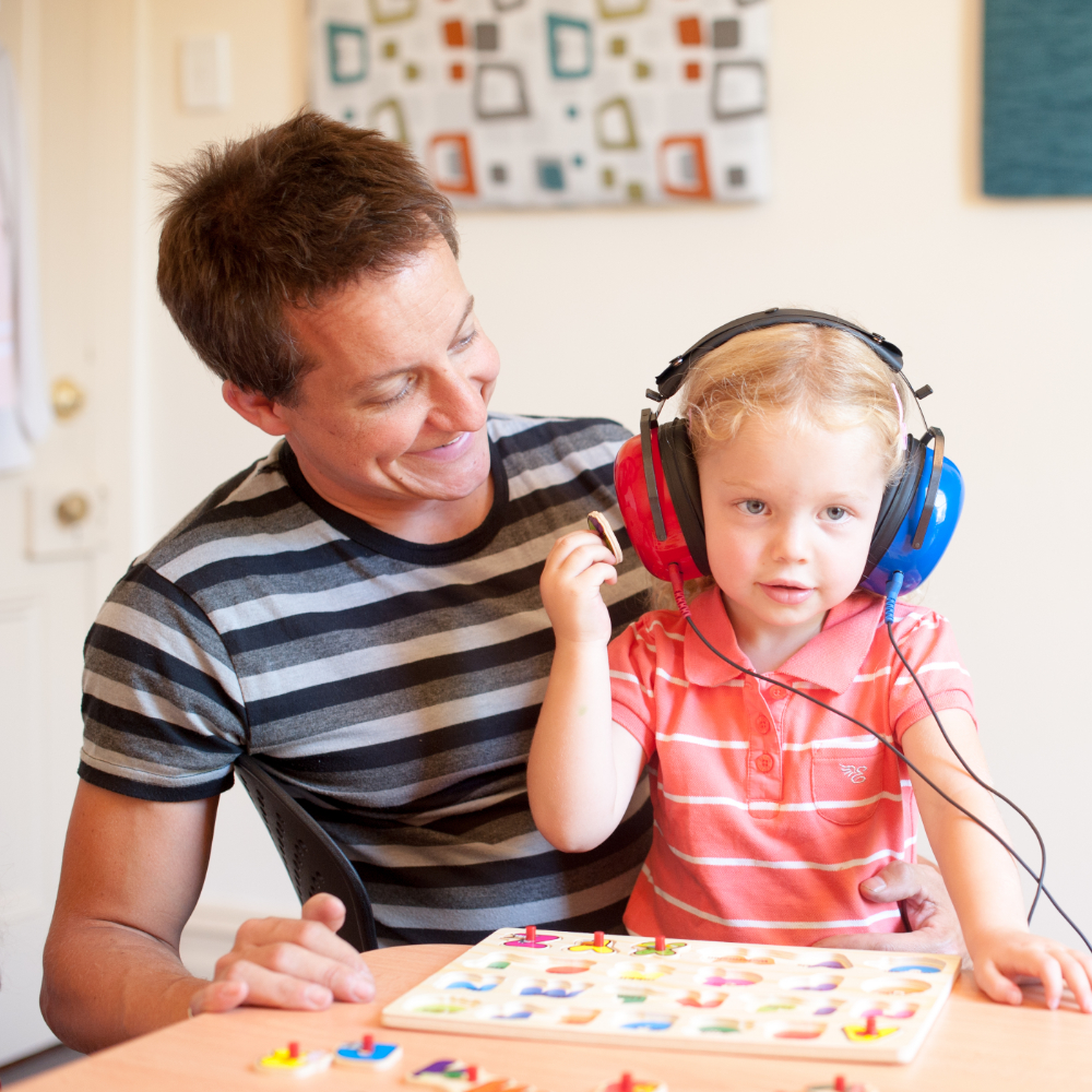 Young child with father having their hearing tested by play audiometry in Adelaide SA