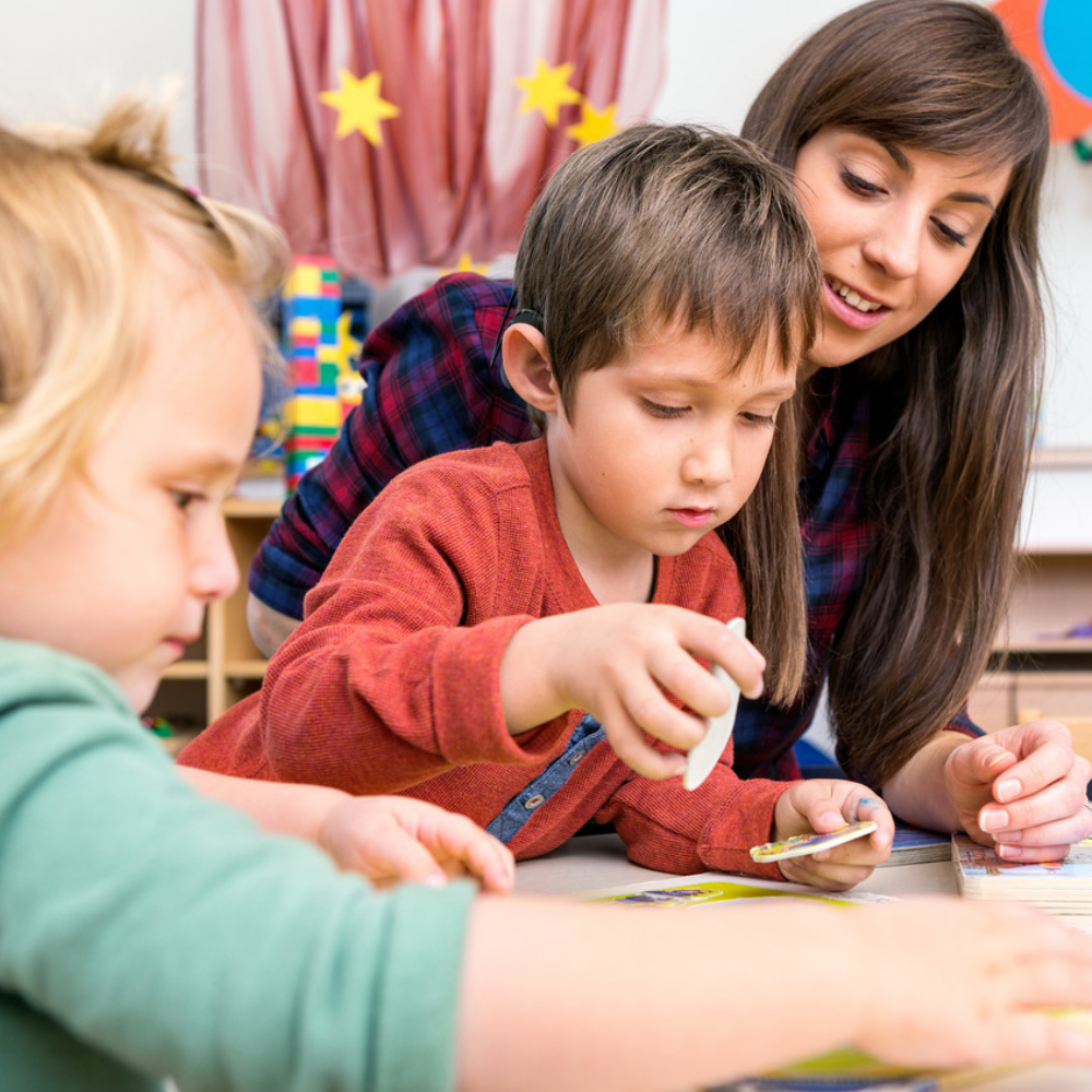 Child playing with sibling and mother using the MED-EL Synchrony implantable hearing device