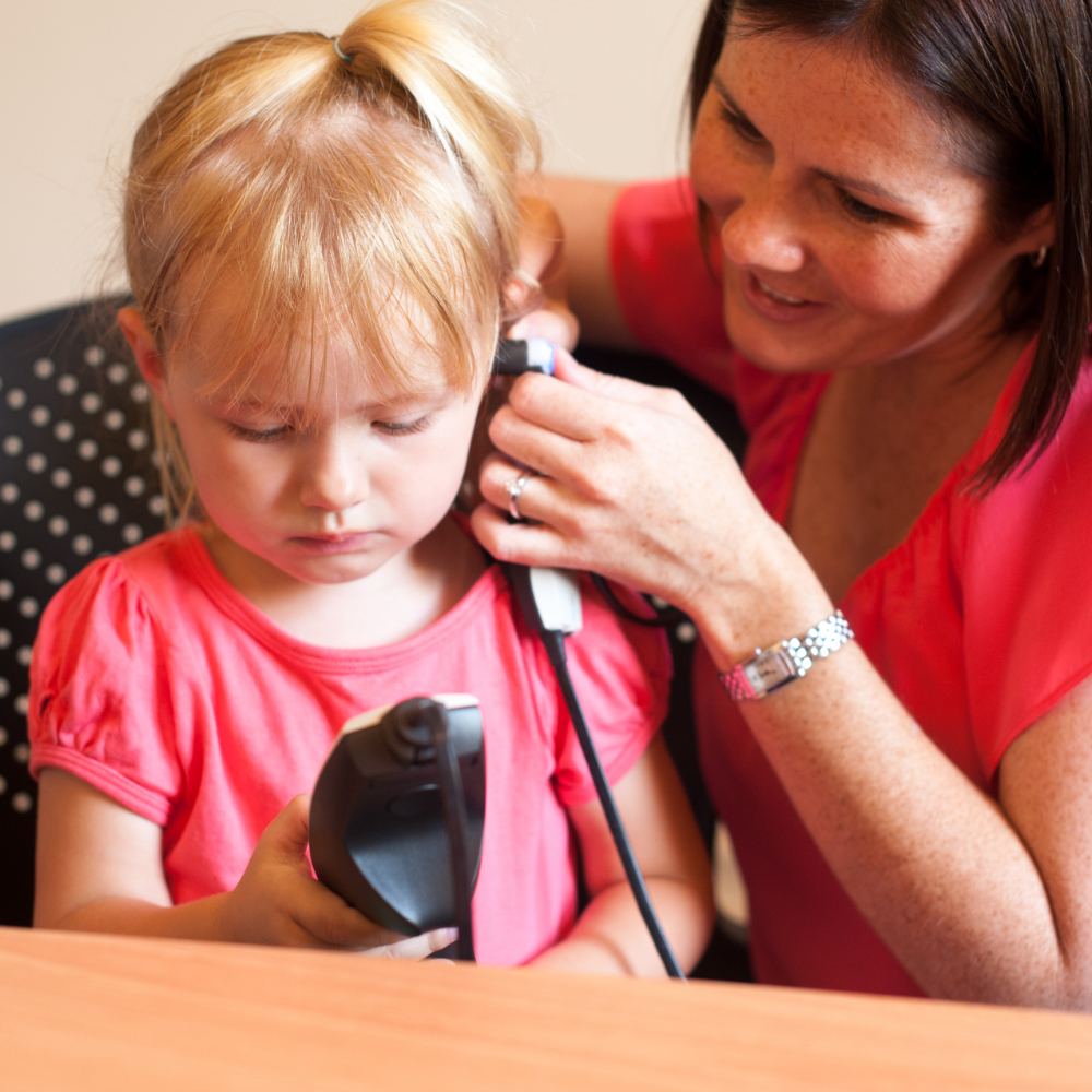 Young girl in a pink top having hear middle ear health assessed at Little Allied Health in Adelaide